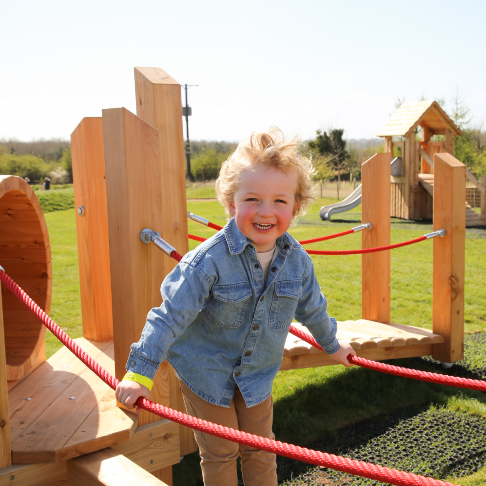 little blonde boy on under 4's play area