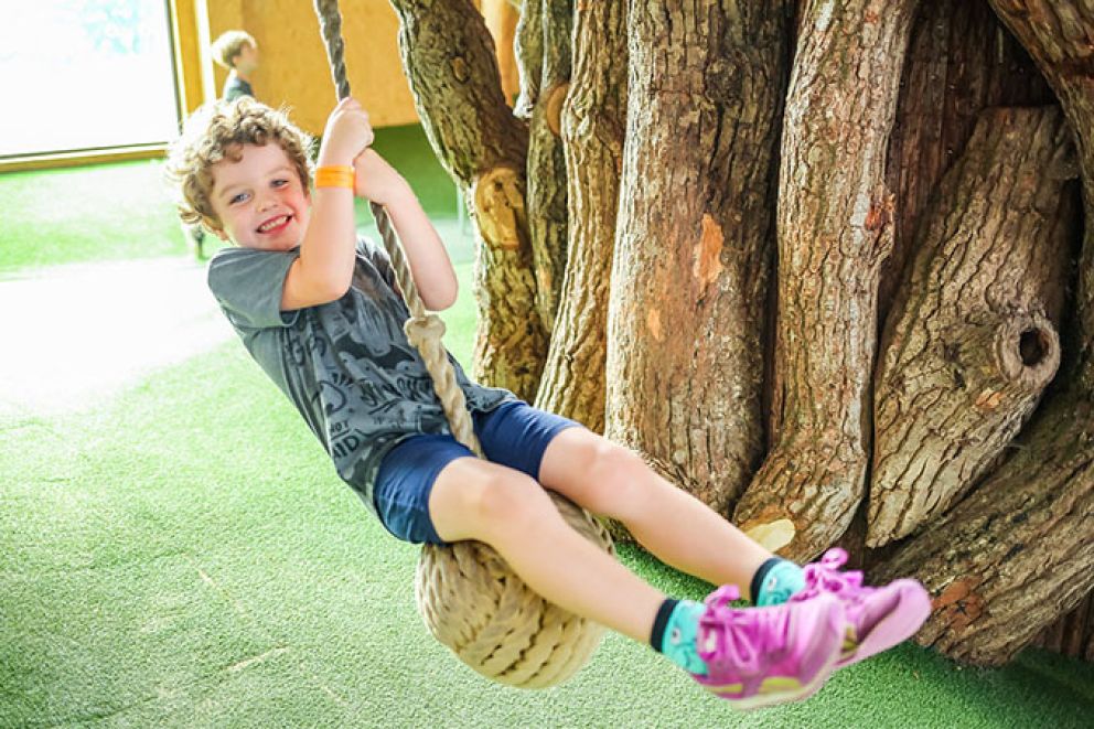 Kid swinging on rope swing