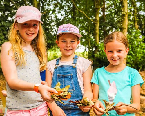 Kids with leaves at William's Den