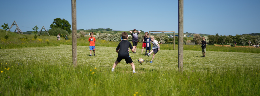 Kids playing football at Williams Den